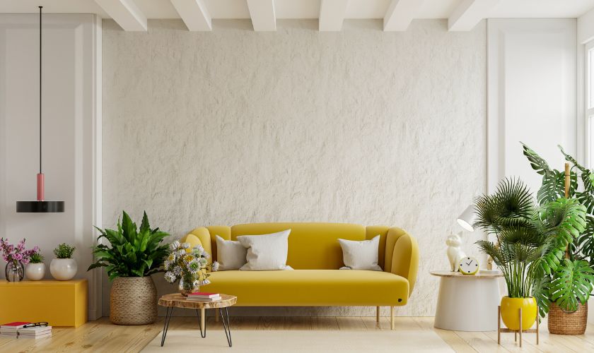 Fabric daybed sofa in a studio apartment with storage ottoman and wall-mounted shelving for Bangalore flat