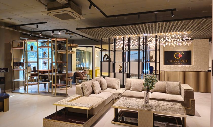Best sofa colour for Indian living room — beige fabric sofa with terracotta and ivory cushions in warm Bangalore interior