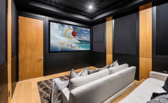 Home theatre setup Bangalore — 3-seater motorised recliner sofa with TV wall and ambient lighting in Bangalore apartment