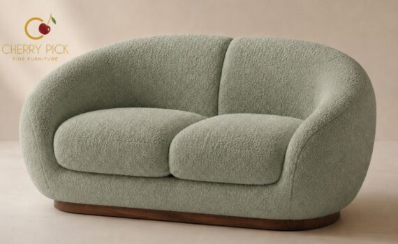 Bucket sofa in boucle upholstery placed on a rug in a modern Bangalore living room