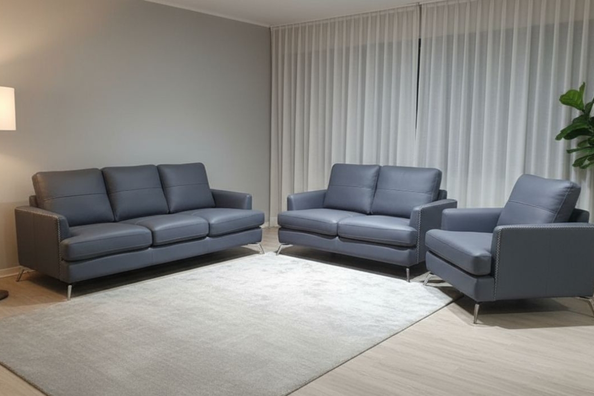 Mix match furniture combining a fabric sofa with a leather accent chair on one rug
